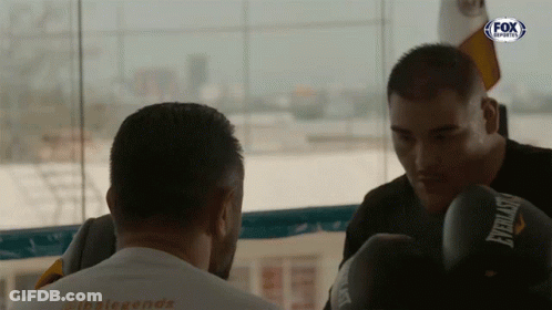 Man In Everlast Boxing Gloves Looking At Another Man GIF