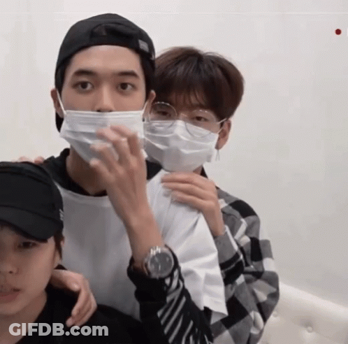 Man In Face Mask And Glasses Holding Another Man's Arm GIF