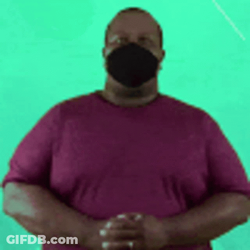 Man In Face Mask And Purple Shirt With Hands Folded GIF