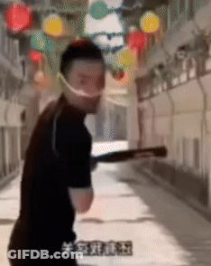 Man In Face Mask Holding Bat In Hallway GIF