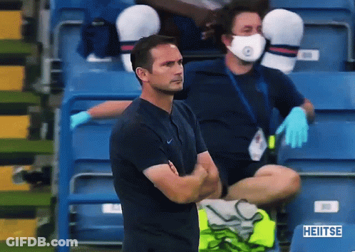 Man In Face Mask Sitting In Stadium With Sign Saying Heiitse GIF