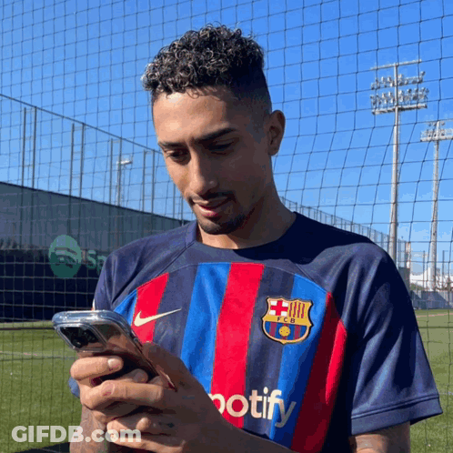 Man In FC Barcelona Shirt Looking At Phone GIF