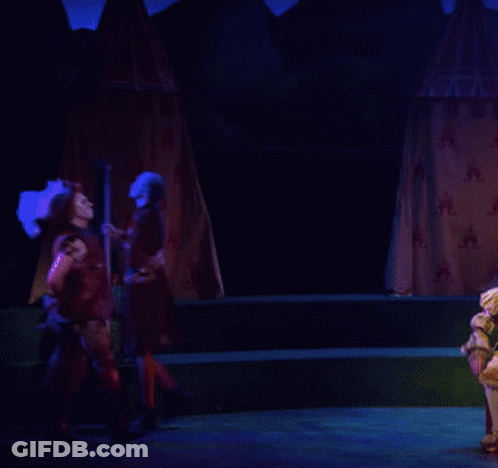 Man In Feathered Hat On Stage GIF