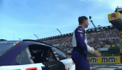 Man In FedEx Shirt Beside M&M's Sign GIF