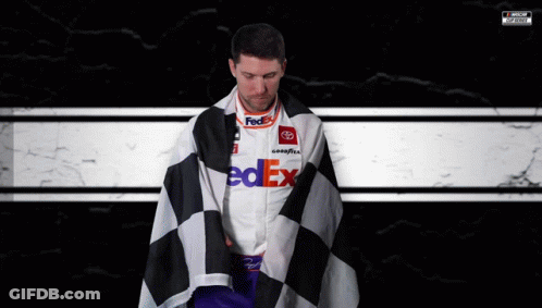 Man In FedEx Shirt Wrapped In Checkered Flag GIF