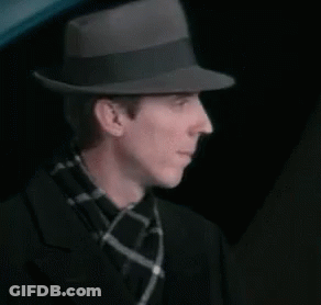 Man In Fedora And Plaid Scarf Adjusting Hat GIF