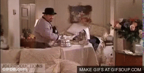 Man In Fedora At Messy Table GIF