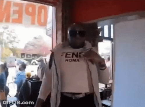 Man In Fendi Roma Shirt At Open Sign GIF