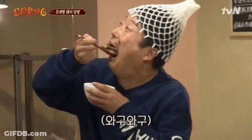 Man In Fishnet Hat Eating Food With TVN Sign GIF