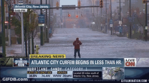 Man In Flooded Street In Front Of CNN Breaking News GIF