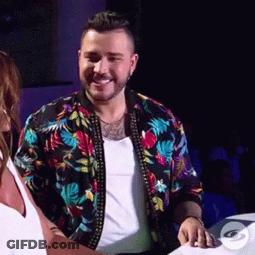 Man In Floral Jacket Beside Woman In White Tank Top GIF