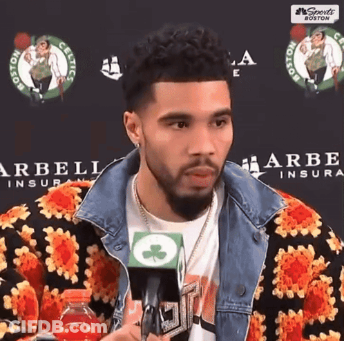 Man In Floral Jacket Talking Into Microphone GIF