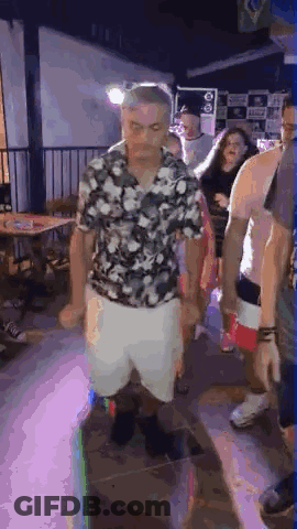Man In Floral Shirt And White Shorts Dancing At Party GIF