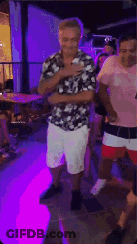 Man In Floral Shirt And White Shorts Dancing GIF
