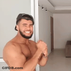 Man In Floral Shirt Dancing Holding Framed Picture GIF
