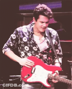 Man In Floral Shirt Holding Red Guitar GIF
