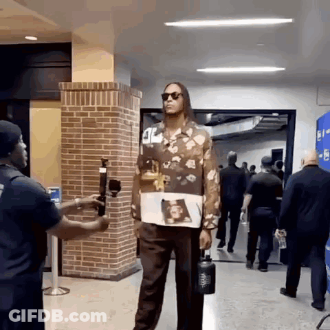 Man In Floral Shirt Holding Water Bottle GIF