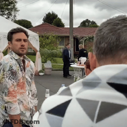 Man In Floral Shirt In Front Of House GIF
