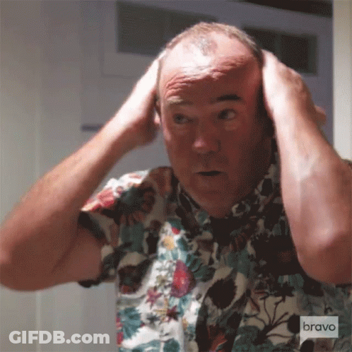 Man In Floral Shirt Looking In Mirror GIF