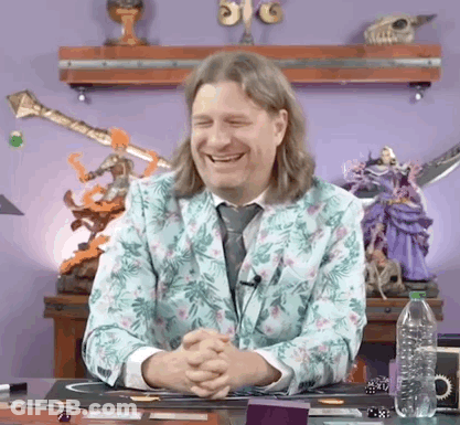 Man In Floral Suit Smiling With Folded Hands At Desk GIF