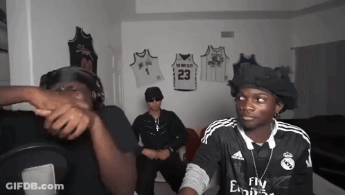 Man In Fly Emirates Jersey Talking To Another Man GIF