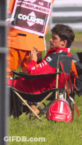 Man In Folding Chair With Course Sign GIF