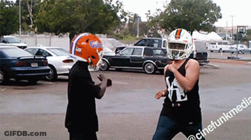 Man In Football Helmet Next To Man In Tank Top With Letter K GIF