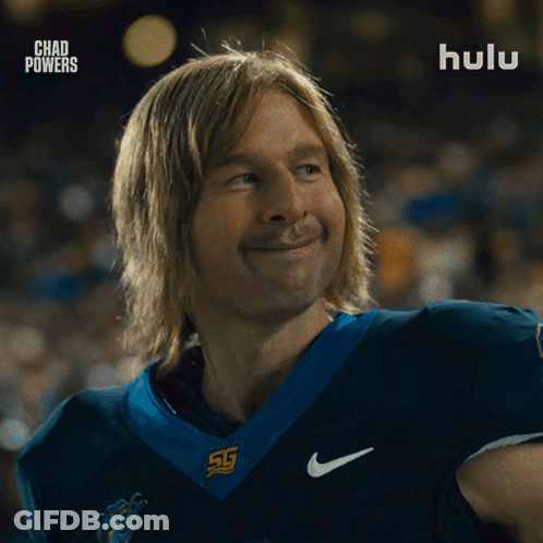 Man In Football Uniform Smiling In Front Of Hulu Ad GIF