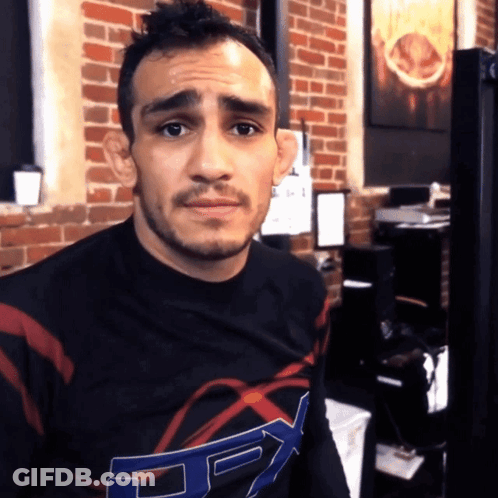 Man In Fox Shirt Looks At Camera GIF