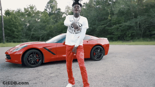 Man In Freedom T-Shirt Near Red Car GIF