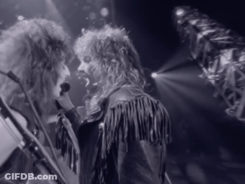 Man In Fringed Leather Jacket Singing Into Microphone GIF