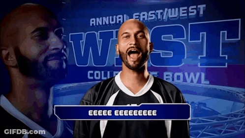 Man In Front Of Annual East West College Bowl Banner GIF