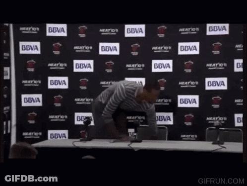 Man In Front Of BBVA Logo Wall GIF
