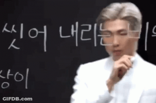 Man In Front Of Blackboard With Korean Writing GIF