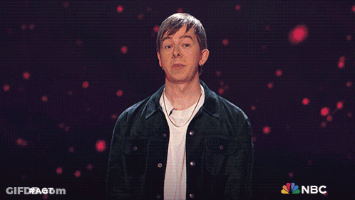 Man In Front Of Blue Background With NBC Logo GIF