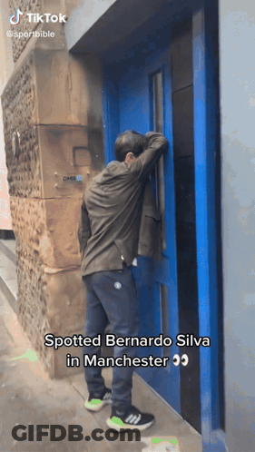 Man In Front Of Blue Door Saying Spotted Bernardo Silva In Manchester GIF