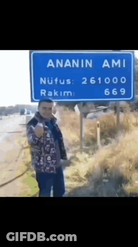 Man In Front Of Blue Sign Saying Ananin Ami GIF