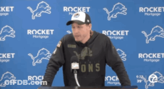 Man In Front Of Blue Wall With Rocket Mortgage GIF