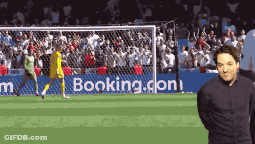 Man In Front Of Booking.com Ad GIF