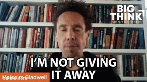 Man In Front Of Bookshelf Says I'm Not Giving It Away GIF