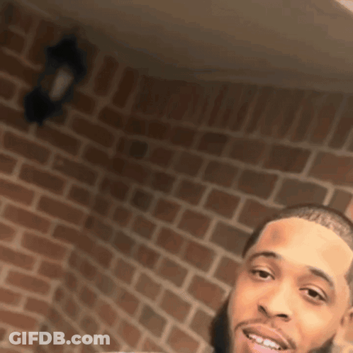 Man In Front Of Brick Wall GIF