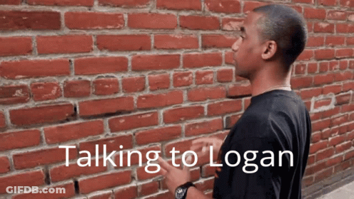 Man In Front Of Brick Wall Saying Talking To Logan GIF