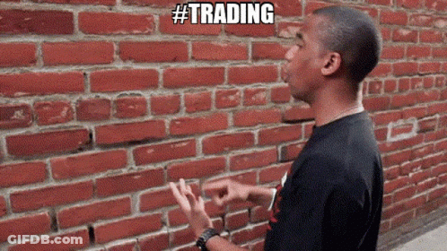 Man In Front Of Brick Wall Saying Trading GIF