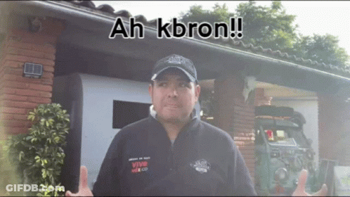 Man In Front Of Building With Ah Kbron GIF
