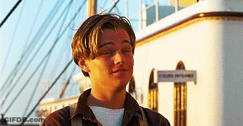 Man In Front Of Building With Titanic Sign GIF