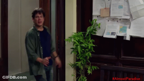 Man In Front Of Bulletin Board Saying Almost Paradise GIF