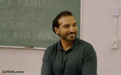 Man In Front Of Chalkboard Saying Desks Cleared GIF