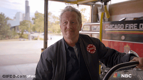 Man In Front Of Chicago Fire Department Vehicle GIF