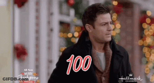 Man In Front Of Christmas Tree Saying Merry Thanksgiving GIF