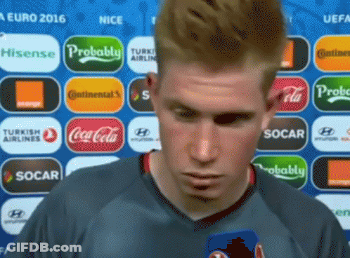 Man In Front Of Coca Cola And Socar Logos GIF